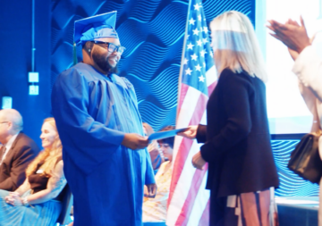 Samahj recieving his diploma at the 2026 Goodwill Helms Academy Graduation Ceremony
